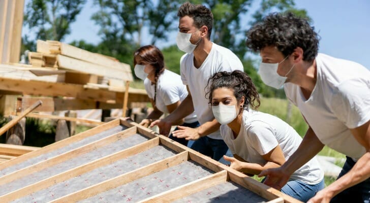Corporate volunteers building a house for a poor family