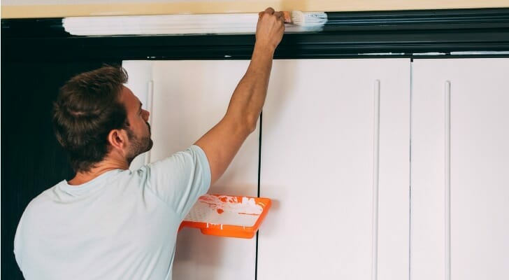 Man painting a house interior