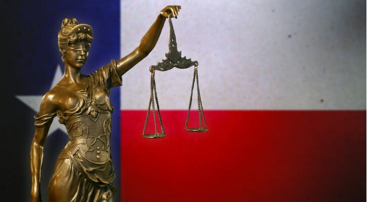 Lady Justice with the Texas flag in the background