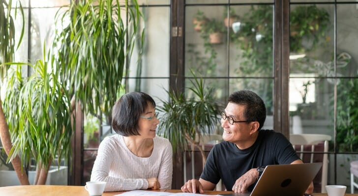 Image shows a couple going over their finances. New research from Morningstar suggests retirees may need to tweak their initial withdrawal rates from 4% to 3.3%.