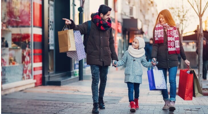 Image shows a young family shopping during the holiday season. SmartAsset set out to determine which cities are best for holiday shopping based on eight different metrics. 