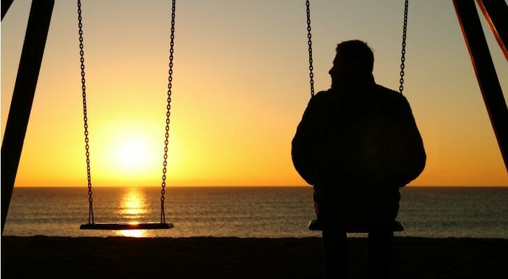 Man on a swing set alone