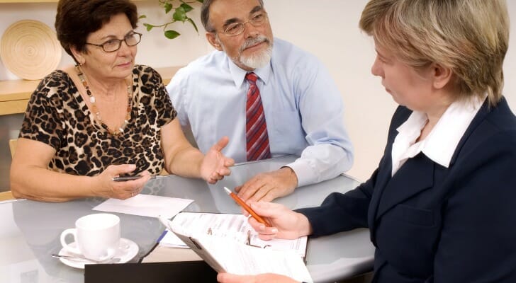 A couple discusses estate planning with a financial advisor.