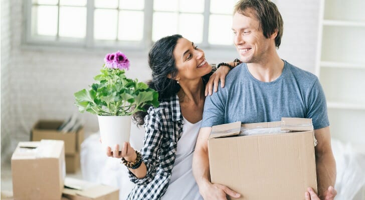 Image shows two high-earning young professionals moving into a new home. SmartAsset analyze data from the IRS to conduct its 2021 study on where rich young professionals are moving.