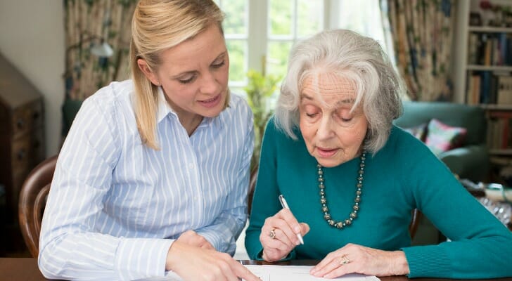 Older lady signing a power of attorney form