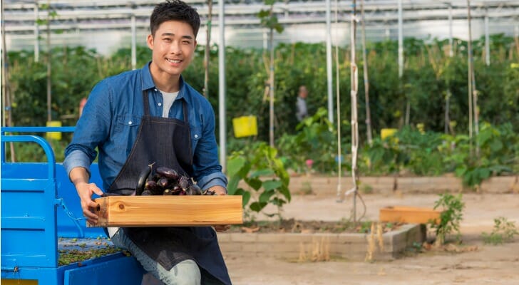 Asian-American farmer in a greenhouse