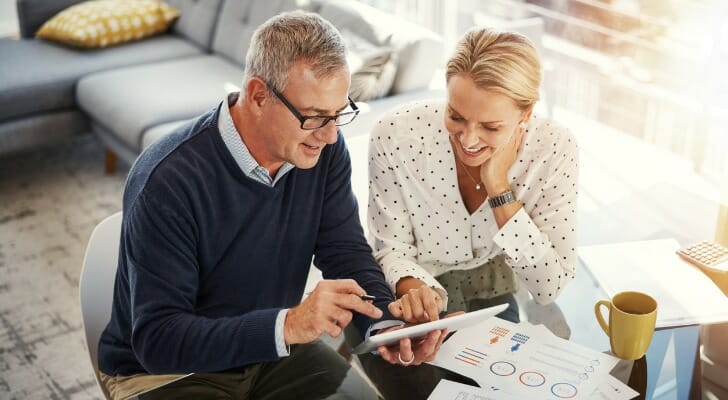 Image shows a couple reviewing their retirement plan. Fidelity Investments plans to launch a new product next year that will allow individuals to shift a portion of their employer-sponsored retirement plan into an annuity.