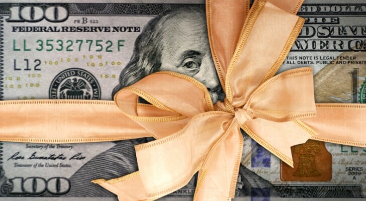 $100 bills wrapped in a bow