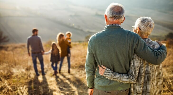 A retired couple enjoys a hike with their family. An expert from Morningstar argues that equities are far more important in retirement than bonds. 