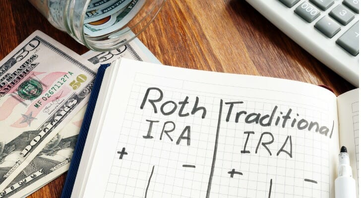 Image shows a person starting to compare a traditional IRA to a Roth IRA. Which option is best for your largely depends on your current and future tax rate.