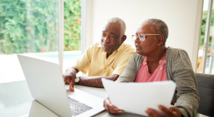 A retired couple reviews their finances together. Researchers at Boston College recently explored the consumption rates of retirees and identified some significant long-term trends.
