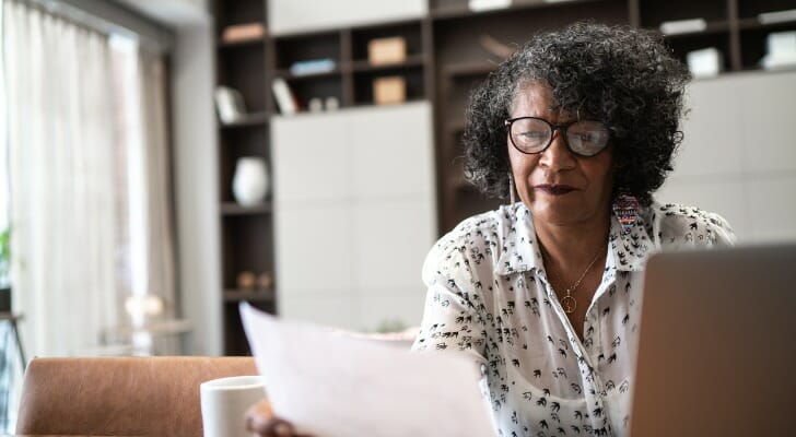 A woman reviews the available investment options in her retirement plan. The U.S. Supreme Court sided with employees at Northwestern University who sued the school over the allegedly excessive fees of their retirement plans, among other issues. 