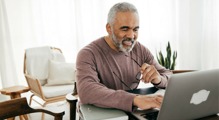 Man smiling at his computer