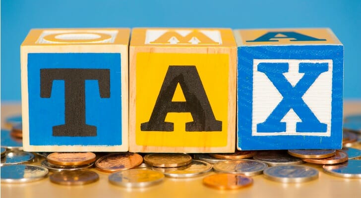 The word "TAX" spelled out with blocks