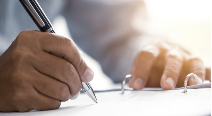 Man signing an estate planning document