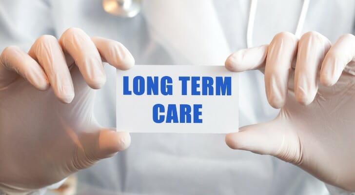 "LONG TERM CARE" sign being held by a doctor