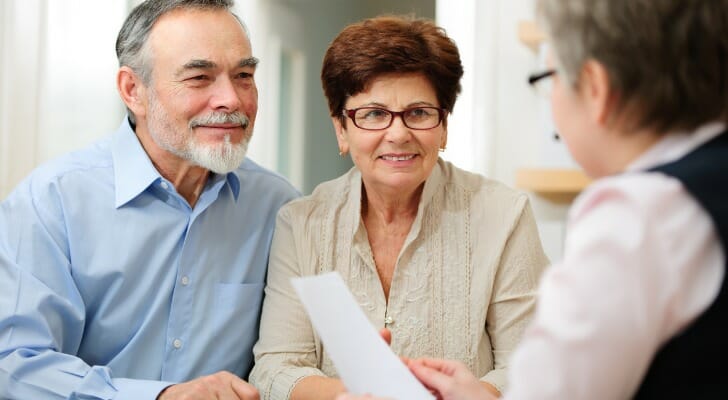 A couple speaks to a financial advisor for help planning their retirement in 10 years.