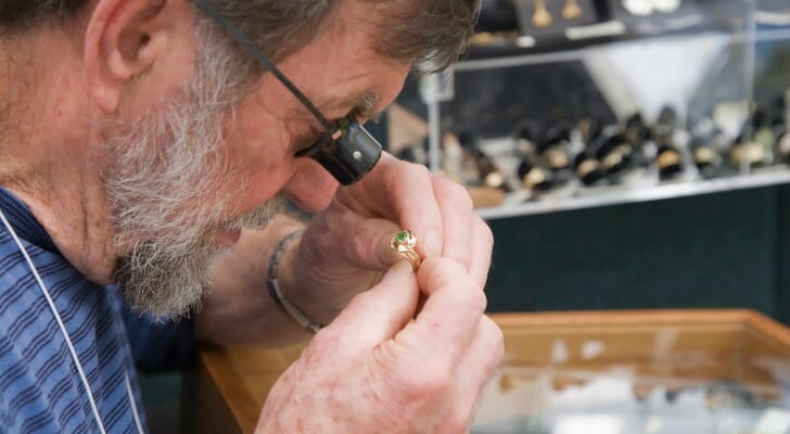 Jeweler appraising engagement ring