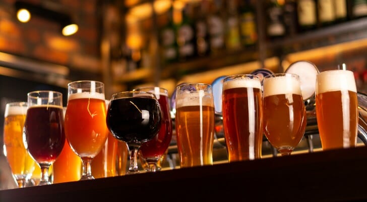 Image shows an array of beers on top of a bar. SmartAsset set out to determine which cities are best for beer drinkers using five different metrics .