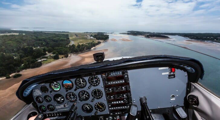 The view from the cockpit of a small airplane as it approaches a runway to land.