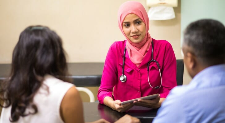 Muslim physician talks with patients.