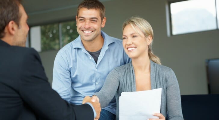A happy couple working with their financial advisor