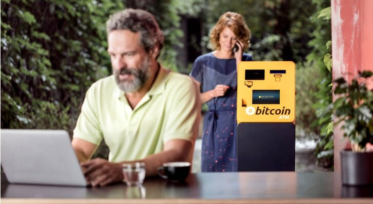 Couple at a cafe with a Bitcoin ATM
