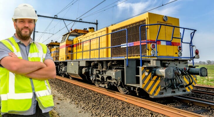 Railroad worker standing by railroad tracks