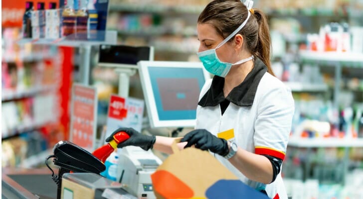 A cashier with mask and gloves
