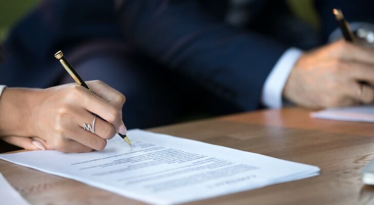 Engage couple signs a prenuptial agreement