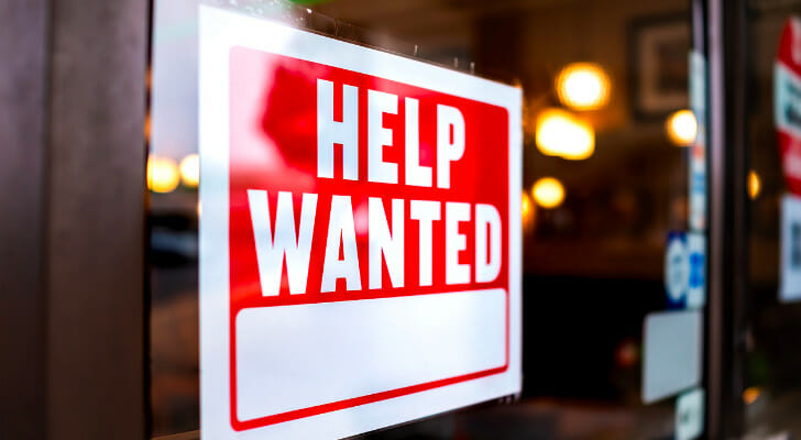 Image shows a red and white "Help Wanted" sign in a window. SmartAsset used BLS data to conduct its latest study on the fastest-growing and fastest-disappearing jobs in each state.