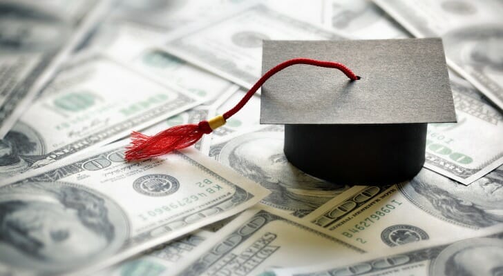 College graduation cap on cash