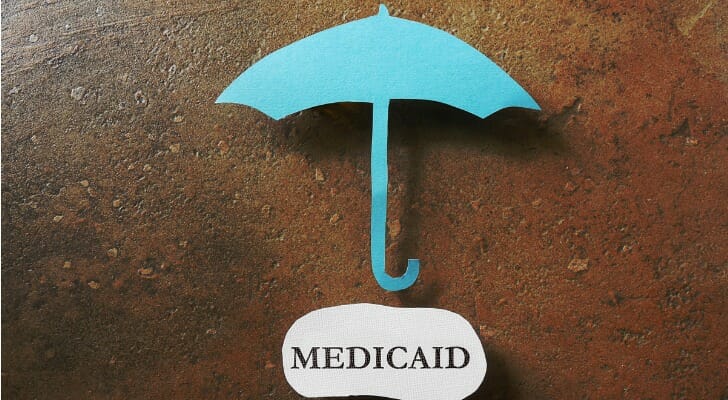 Umbrella over a MEDICAID sign