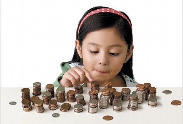 Child counting piles of coins - The High Cost of Having Kids