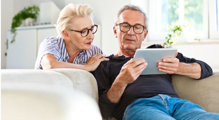 Senior couple uses an online trading platform