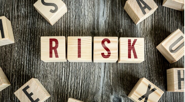 "RISK" spelled out in wooden blocks