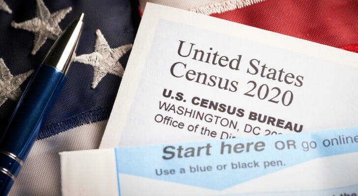 Images shows a blank U.S. Census 2020 form and a pen against an American flag. SmartAsset analyzed recent Census data to find where self-response rates have increased the most between May 4 and August 18, 2020.