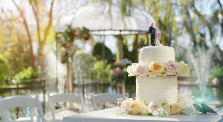 A wedding cake sits on a table at a wedding reception. SmartAsset examined 97 of the largest cities in the U.S. to find the best cities for an affordable wedding.