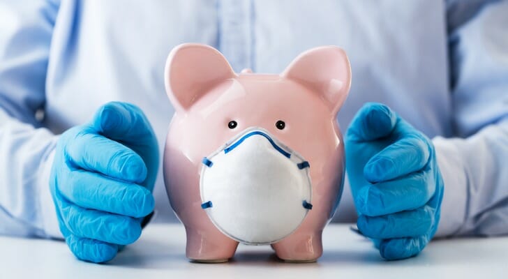 A piggy bank with a face mask represents the need for Oregon coronavirus relief.