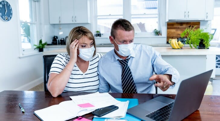 A couple wearing face masks look confused as they try to make sense of the many Vermont coronavirus relief programs available.