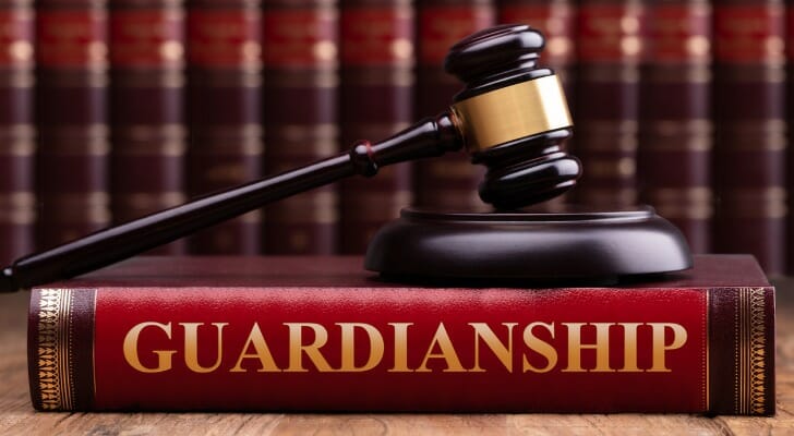 A gavel rests on top of a law book whose spine reads, "Guardianship." SmartAsset takes a closer look at the ins and outs of adult guardianship.