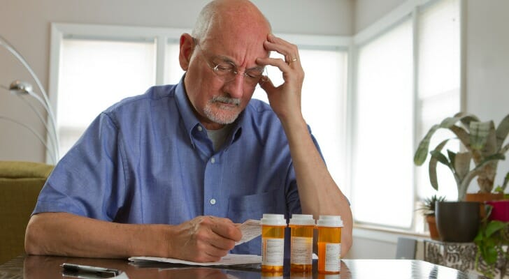 Older man trying to figure out how to pay his medical bills