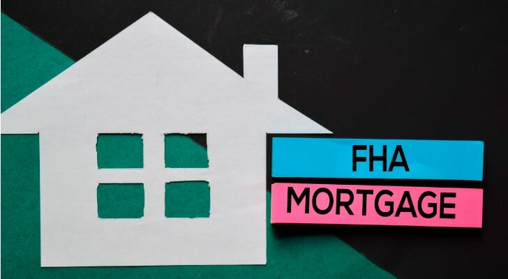 "FHA MORTGAGE" sign with paper cutout house
