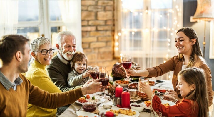 A happy, multigenerational family enjoying a meal together at the dinner table