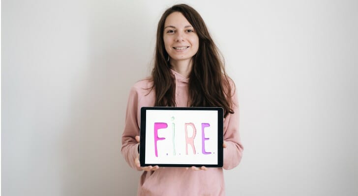 Young woman holding a FIRE sign