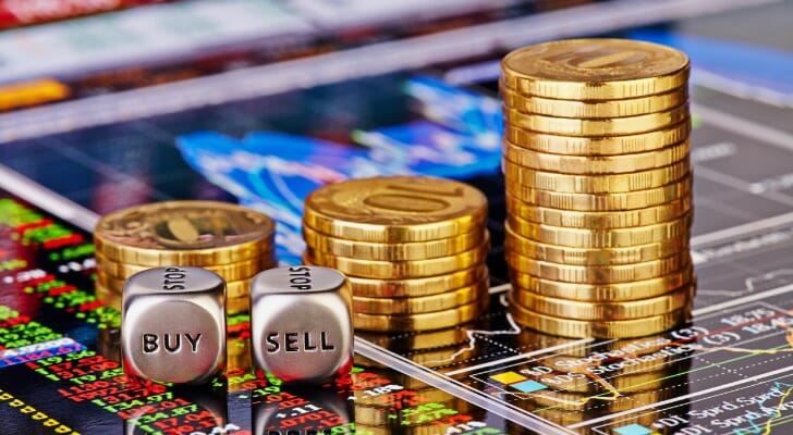 Stack of gold coins on a digital price chart